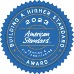 Blue Circular Emblem With &Quot;Building A Higher Standard,&Quot; &Quot;2023,&Quot; &Quot;American Standard Heating &Amp; Air Conditioning,&Quot; &Quot;Gibson,&Quot; And &Quot;Award&Quot; Written In White And Gold Text.